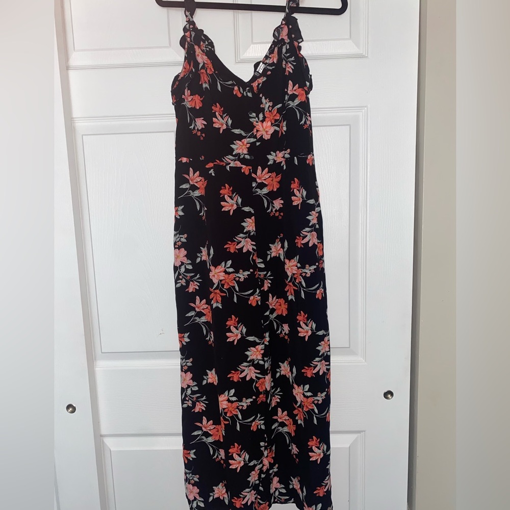 Black floral jumper with ruffles on the shoulders and around the front and back